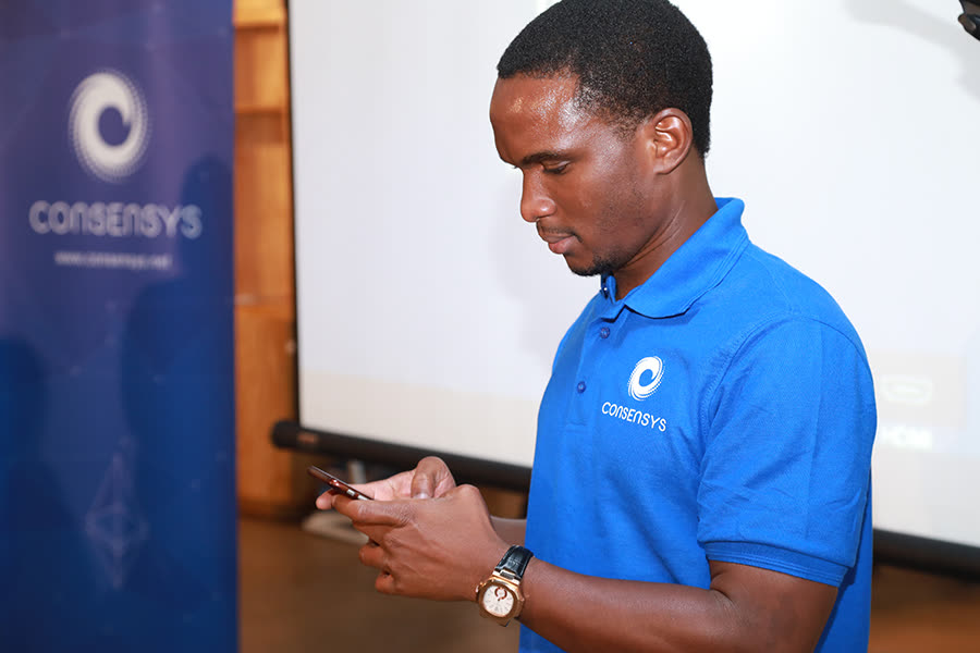 EthJoburg 2 — Final checks beside the ConsenSys banner.