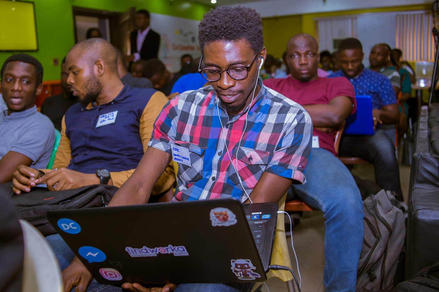 EthLagos 1 — Lagos developers and founders arriving with laptops open.