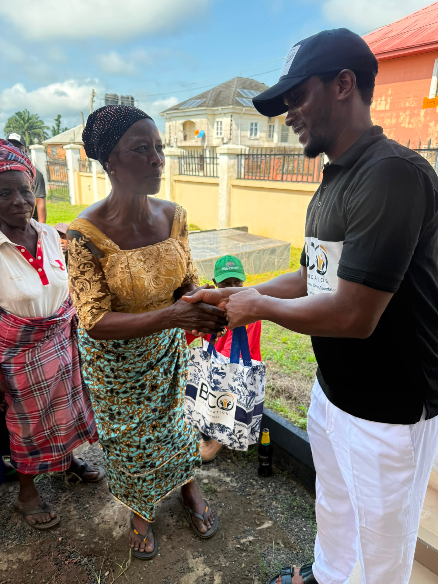 A woman receiving a BCO Foundation relief bag